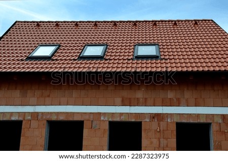 construction work on a house made of modern insulating bricks. roof windows, new housing. Windows openings, price of masonry. weekly companies, quality of work, companies