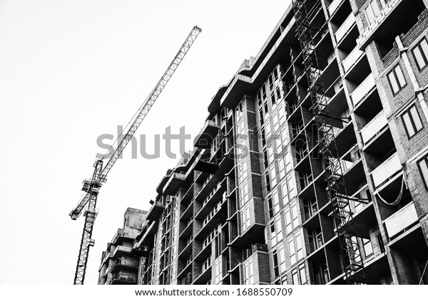 construction work on a\
tall house with a\
crane