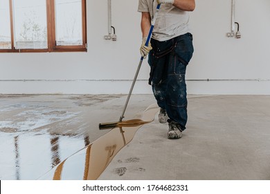 A Construction Worker Apply Epoxy Resin In An Industrial Hall