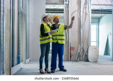 Construction Worker And Architect Discussing Work To Be Done At Site To Finish The Building