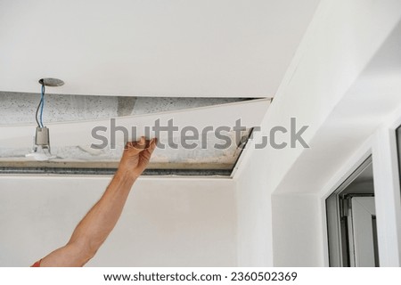 Construction worker assemble a suspended ceiling.