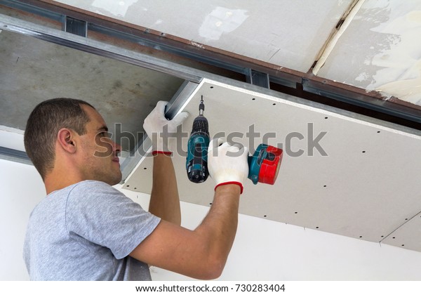 Construction Worker Assemble Suspended Ceiling Drywall Stock Photo