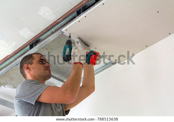 Construction Worker Assemble Suspended Ceiling Drywall Stock