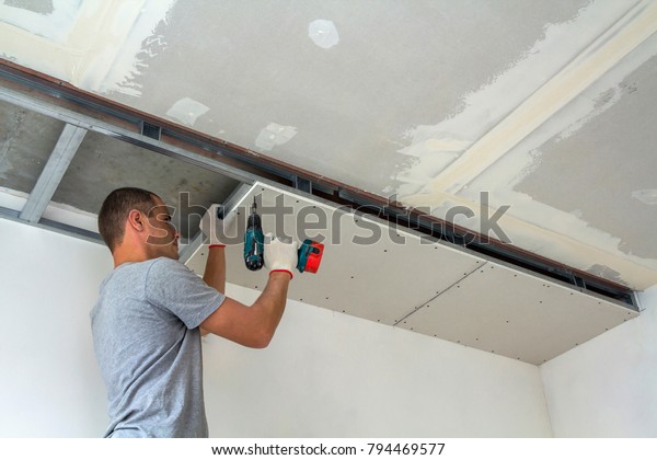 Construction Worker Assemble Suspended Ceiling Drywall Stock Photo