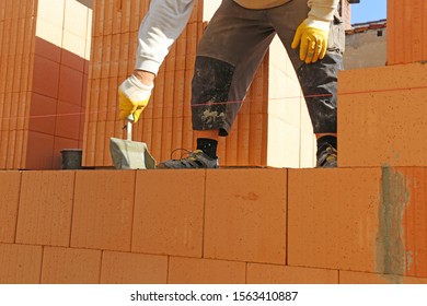 Construction Worker (bricklayer) Working On The Construction Site