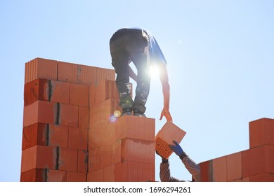 Construction Worker (bricklayer) Works On The Construction Site