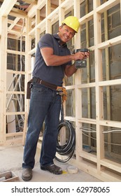 Construction Worker Building Timber Frame In New Home