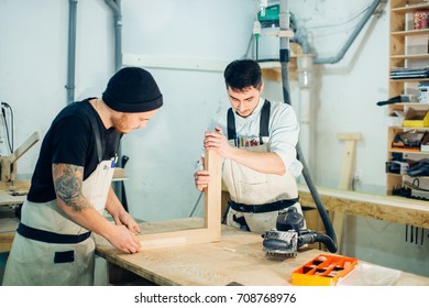 Construction Worker Building Timber Frame In New Home