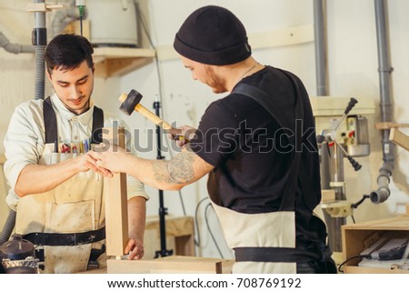 Construction Worker Building Timber Frame In New Home