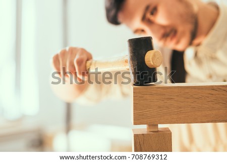 Construction Worker Building Timber Frame In New Home.