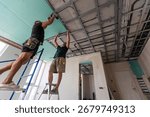 Construction worker ceiling work installation