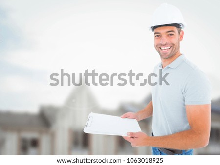 Construction Worker with chart in front of construction site