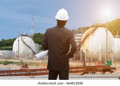Construction worker checking blueprints on site