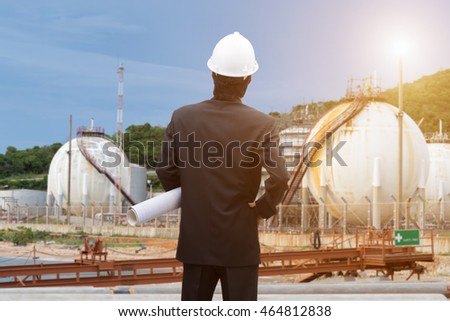 Construction worker checking blueprints on site