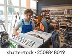 Construction worker choosing table circular saw while shopping at power tools shop