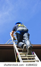 Construction Worker Climbing Extension Ladder To Roof