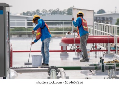 Construction Worker Coating Epoxy Paint At Roof Slab For Water Proof Protection