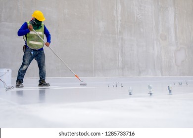 Construction Worker Coating Floor By Epoxy 