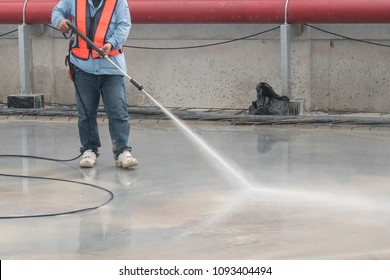 Construction Worker Concrete Floor Cleaning With High Pressure Water Jet