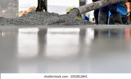 Construction worker Concrete pouring during commercial concreting floors of building in construction site and Civil Engineer