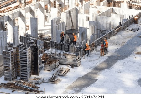 Construction worker Concrete pouring during commercial concreting floors of building in construction site and Civil Engineer or Construction engineer inspec work
