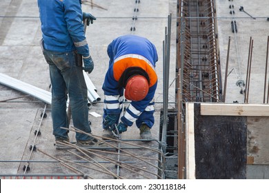 Construction worker connects fittings wire - Shutterstock ID 230118184