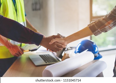 Construction Worker And Contractor. Client Shaking Hands With Team Builder In Renovation Site.