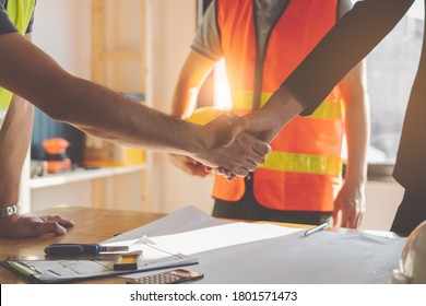 Construction Worker And Contractor. Client Shaking Hands With Team Builder In Renovation Site.