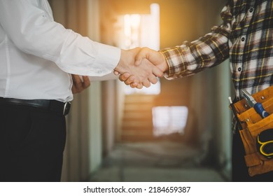 Construction Worker And Contractor. Client Shaking Hands With Team Builder In Renovation Site.