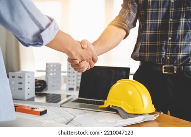 Construction Worker And Contractor. Client Shaking Hands With Team Builder In Renovation Site.