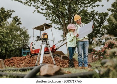 Construction Worker And Daughter At A Construction Site