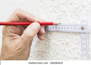 Construction Worker Drawing Straight Line Using Folding Ruler