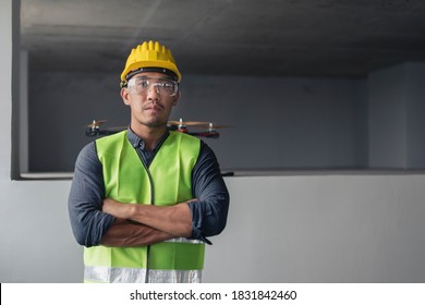 Construction Worker With Drone. Asian Contruction Worker In Building Site.