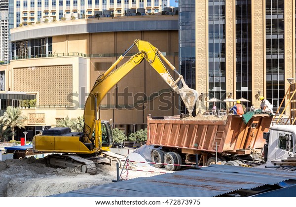 Construction worker in Dubai Marina  in a summer\
day, United Arab\
Emirates
