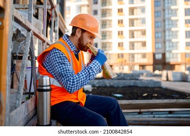 Construction Worker Eating Sandwich During Lunch Break