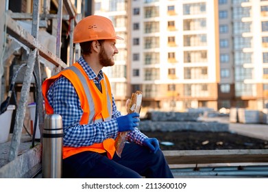 Construction Worker Eating Sandwich During Lunch Break