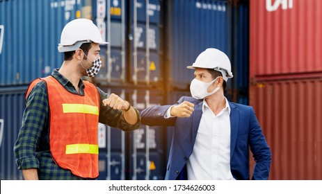 Construction Worker Or Engineer Greeting Bumping Elbows Wear Safety Helmet And Mask In The Factory Or Container. Prevent Accidents Work Or Dust And Coronavirus. Social Distancing. Concept New Normal