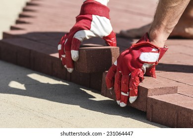 Construction worker fixing the pavestone on the road