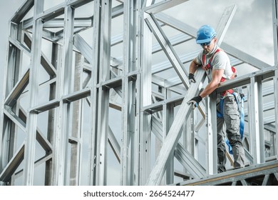 A construction worker is focused on assembling metal framework at a building site under clear skies. Safety gear is notably worn during this task. - Powered by Shutterstock - Get 15% off with code: PIKWIZARD15