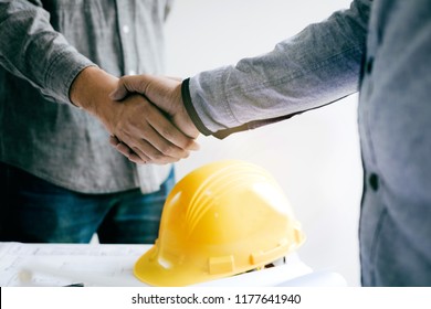 Construction Worker Greeting A Foreman At Renovating Apartment.