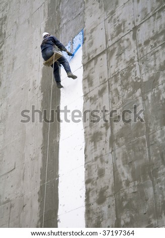 Construction worker and grey cement wall white line