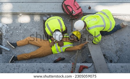 A construction worker had an accident at work, fell from a height, seriously injured. First aid to save the lives of construction site workers in an accident.