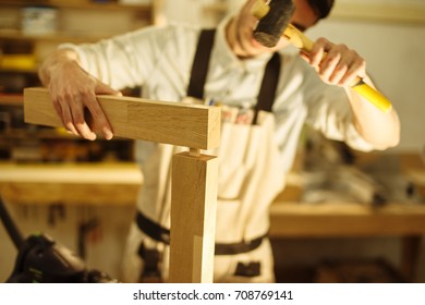 Construction Worker with hammer Building Timber Frame In New Home
