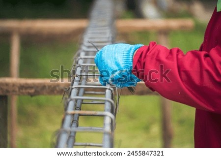 Construction Worker hands using pincer pliers iron wire. Outdoor Worker using wire bending pliers, construction work. Men hands bending cutting steel wire fences bar reinforcement of concrete work