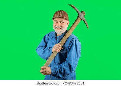 Construction worker in hard hat with pickaxe. Smiling builder man in uniform with pick-axe on shoulder. Mining industry. Mature coal miner with pickax. Male laborer with hand tool for digging, mining.