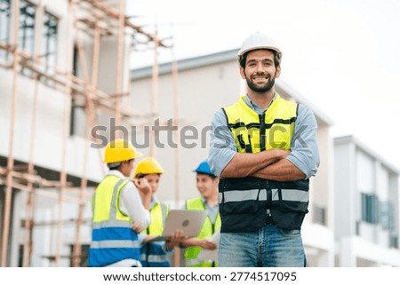 Construction worker hard hat safety vest building site engineer smiling man arms crossed outdoor teamwork project