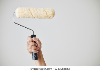 Construction Worker Holding Fluffy Roll He Is Using For Application Of Paint On The Wall