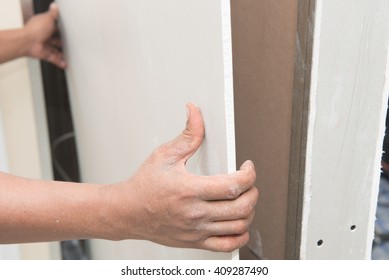 Construction Worker Holding Gypsum Board