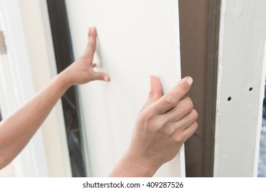 Construction Worker Holding Gypsum Board