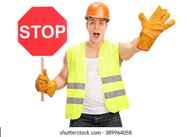 Construction Worker Holding A Stop Sign And Gesturing With His Hand Isolated On White Background